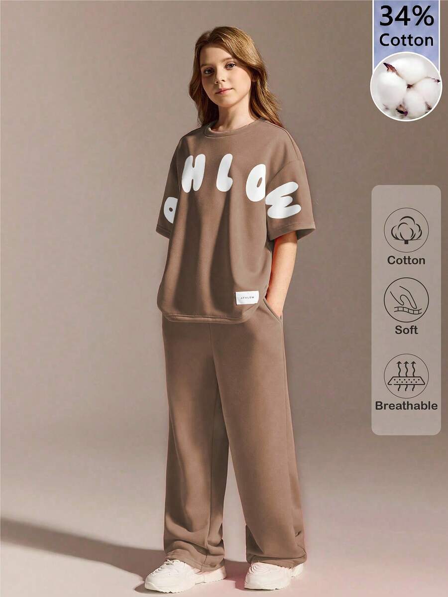 SHEIN مجموعة رياضية كاجوال للفتيات المراهقات، تي شيرت فضفاض بياقة مستديرة مقترن مع بنطلون مريح، لون برتقالي-وردي نابض بالحيوية الشبابية، قماش ناعم ولطيف على البشرة، مناسب للارتداء اليومي الكاجوال، المدرسة، والعطلات
