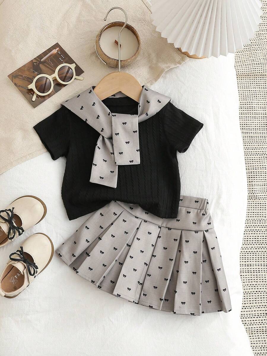 SHEIN Elladie kids 3件/套可愛學院風女嬰夏季套裝,包含1件黑色針織提花圓領短袖T恤、蝴蝶結印花淺灰色披肩以及配套彈性腰褶皺裙,柔軟舒適,時尚休閒街頭風夏季套裝,適合日常穿著、外出、休閒、度假、派對、運動、開學,女嬰制服洋裝套裝,女嬰校服洋裝套裝,女嬰夏季服裝,女嬰夏季套裝,女嬰蝴蝶結裙套裝 - 黑色 - 查看 1