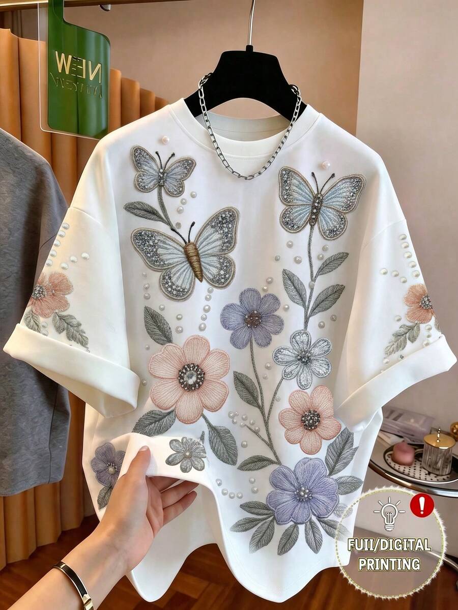 Qadelle 女士圆领蝴蝶花卉刺绣仿珍珠装饰短袖上衣，适合休闲、通勤、约会、派对、居家、外出、下午茶、海滩度假、旅行及各种场合。 - 白色 - 查看 1