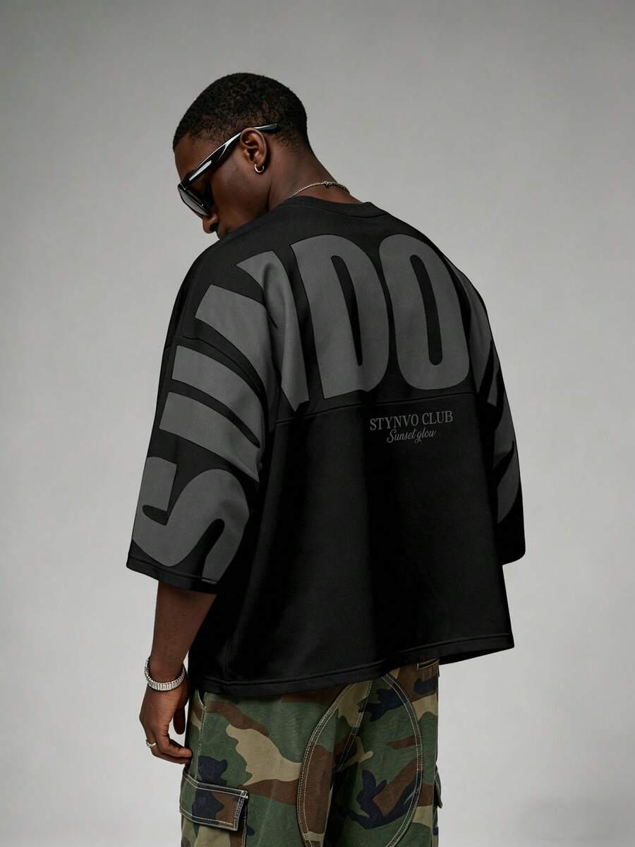 STYNVO Men's Letter Print Round Neck Dropped Shoulder Casual Loose T-Shirt, Holiday - Black - View 1