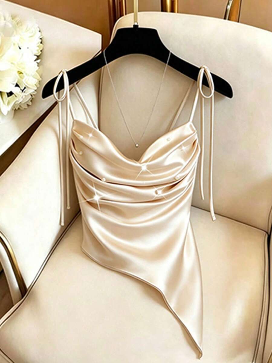GlowEve CURVE Camiseta de tirantes de mujer talla grande de color champán sólido con perlas, bajo irregular con lazo en el hombro, versátil para ir al trabajo, casual, citas, vacaciones, estilo francés elegante, nueva llegada de verano - Champán - Ver 1