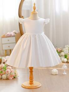 SHEIN Glamorique Kids 女童簡約白色正式禮服，柔軟緞面背部附可拆式大蝴蝶結，花童婚禮禮服，兒童生日公主長裙，晚宴派對服飾，夏季穿搭，迷人大裙擺，時尚正式穿著，派對禮服指南，度假風洋裝，畢業舞會禮服，四季皆宜 - 米色 - 查看 5