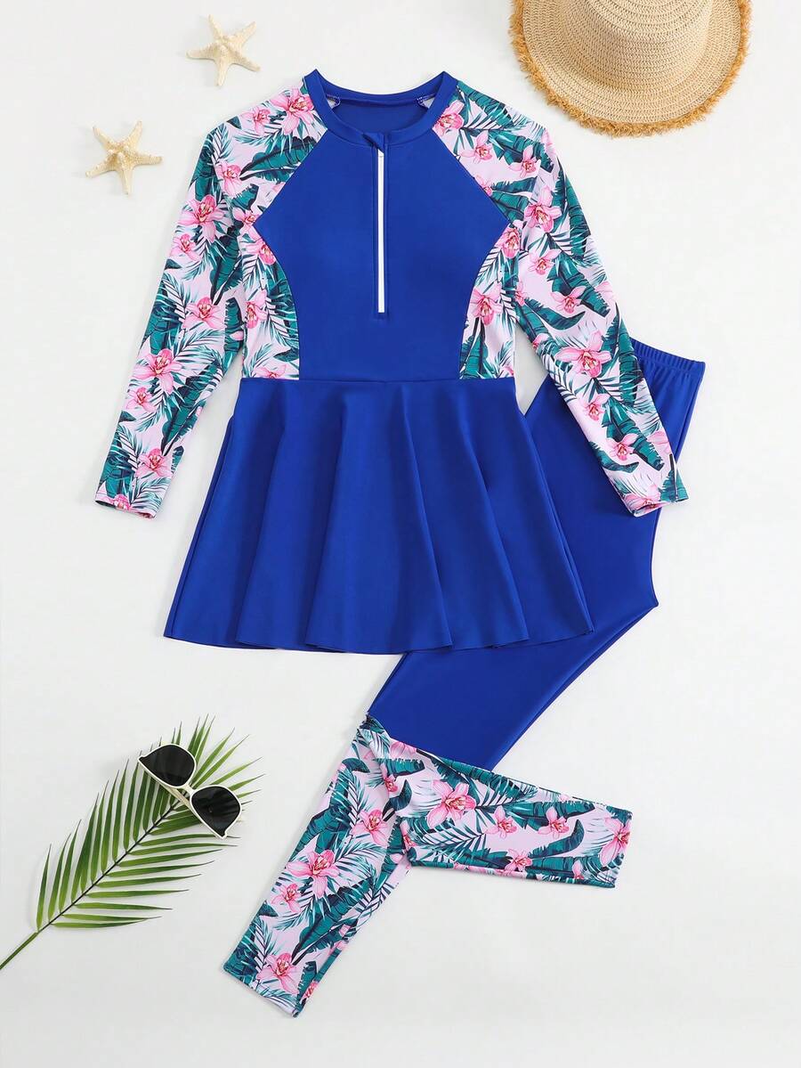 SHEIN 青少年女孩坦基尼比基尼套裝,保守度假風,深藍色身軀搭配粉色與白色熱帶花卉印花(棕櫚葉+粉色花朵)袖口與側縫,半開前拉鍊設計,裙襬,深藍色泳褲搭配相同熱帶花卉印花袖口,2件組,時尚休閒優雅成熟女士風,適合游泳、夏季度假、海灘、海邊、泳池、夏季假期派對、休閒度假 - 寶藍色 - 查看 1
