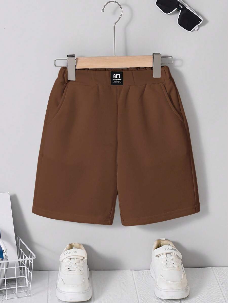 SHEIN Pantalones cortos casuales y cómodos para niño preadolescente con patchwork, unicolor, largo hasta la rodilla y bolsillos inclinados - Marrón - Ver 1