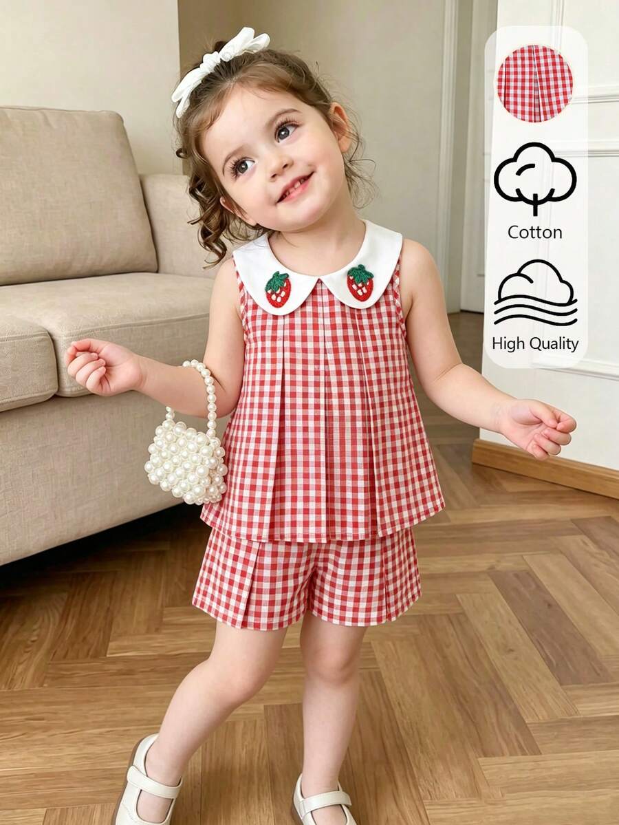SHEIN Elladie kids 女童红白拼接草莓图案无袖上衣+短裤套装。经典的红白拼接梭织面料，白色彼得潘领饰以可爱的草莓图案，上衣采用修身褶皱设计。面料柔软舒适，搭配同色休闲短裤，适合打造可爱夏日造型，是派对、上学、度假、拍照的理想之选。兼具实用时尚、海岛风情、海滩周末休闲和夏季穿着的风格。 - 紅色 - 查看 1