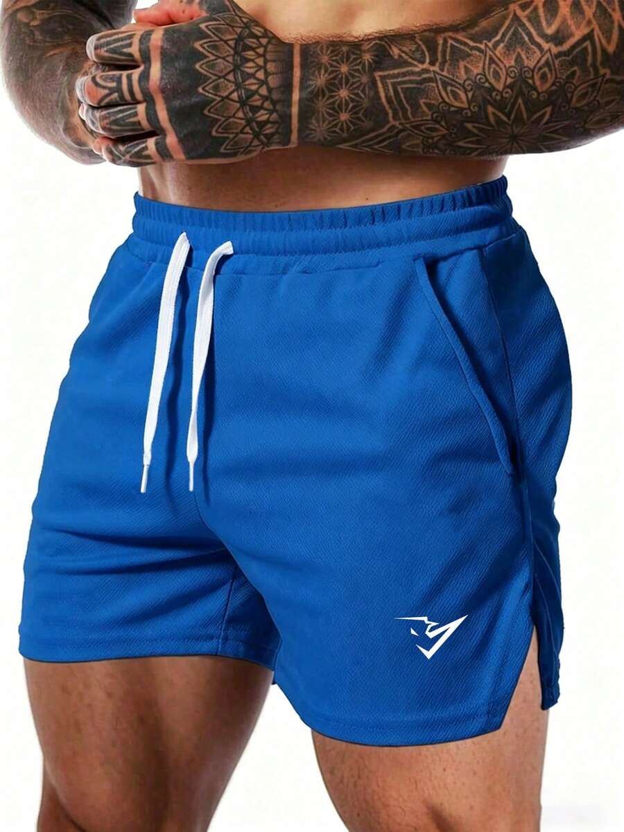 Coreblaze Pantalones cortos deportivos para hombre con estampado de bloques de color, cintura con cordón, bolsillos y bajo dividido - Azul - Ver 1