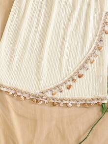 SHEIN Girls' Bohemian Two Pieces Vacation Set In Soft Off-White, Crafted From Crinkled Textured Fabric. Consisting Of A Halter Camisole And A Bodycon Short Skirt, It Is Decorated With Delicate Shell Pendants On The Hems. Full Of Tropical Island Charm, This Outfit Creates A Strong Holiday Vibe, Ideal For Seaside Trips And Vacation Wear - Apricot - View 6
