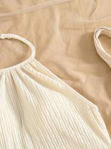 SHEIN Girls' Bohemian Two Pieces Vacation Set In Soft Off-White, Crafted From Crinkled Textured Fabric. Consisting Of A Halter Camisole And A Bodycon Short Skirt, It Is Decorated With Delicate Shell Pendants On The Hems. Full Of Tropical Island Charm, This Outfit Creates A Strong Holiday Vibe, Ideal For Seaside Trips And Vacation Wear - Apricot - View 3