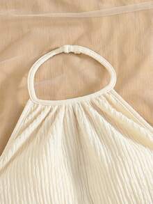 SHEIN Girls' Bohemian Two Pieces Vacation Set In Soft Off-White, Crafted From Crinkled Textured Fabric. Consisting Of A Halter Camisole And A Bodycon Short Skirt, It Is Decorated With Delicate Shell Pendants On The Hems. Full Of Tropical Island Charm, This Outfit Creates A Strong Holiday Vibe, Ideal For Seaside Trips And Vacation Wear - Apricot - View 4