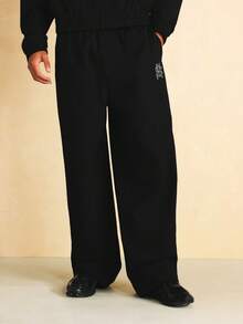 SUMWON Wide Leg Nylon Textured Jogger Pants With Monogram Embroidery Logo Detail And Elastic Waistband - Black - View 1