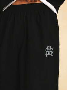 SUMWON Wide Leg Nylon Textured Jogger Pants With Monogram Embroidery Logo Detail And Elastic Waistband - Black - View 7