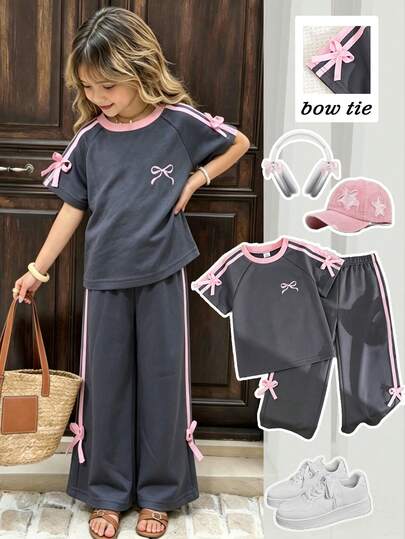 SHEIN Playful Pals Girls' Spring/Summer Casual Fashion New T-Shirt Set, Pink Bow Graphic Print On Front, Pink Woven Ribbon 3D Bow Decor On Sleeves, Pink Ribbed Round Neck Raglan Sleeve T-Shirt Top Paired With Pink Woven Ribbon Bow Grey Solid Color Casual Long Pants, 2-Piece Set Suitable For Daily Wear, School, Vacation