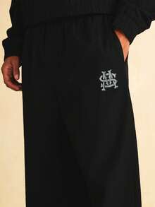 SUMWON Wide Leg Nylon Textured Jogger Pants With Monogram Embroidery Logo Detail And Elastic Waistband - Black - View 6