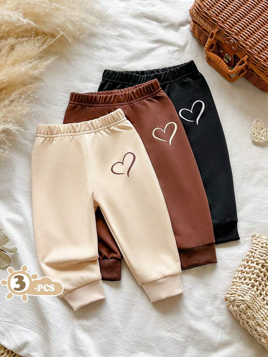 SHEIN Vintaside Kids 女嬰秋冬針織休閒韓系日常基礎百搭三色組合彈性腰收口長褲三件套,褲側飾有簡約鏤空愛心印花圖案,適合居家休閒、戶外活動、秋季出遊、生日派對及各種節日場合 - 彩色 - 查看 1