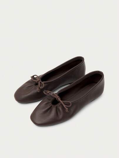 Nöista Deep Brown Ballet Flats With Leather-Effect Finish And Delicate Bow Detail. Timeless Design For Everyday Sophisticated Looks. Casual