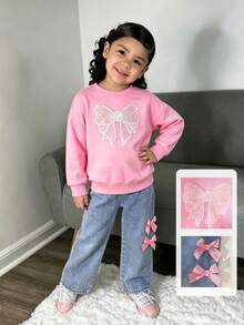 Genkimix Kids 这款女童春秋冬返校新款针织卫衣套装，饰有蝴蝶结图案，圆领长袖设计，搭配粉色蝴蝶结装饰的蓝色牛仔裤，两件套，适合女孩日常穿着，可爱又优雅，适合上学、外出、派对等场合。 - 粉色 - 查看 3