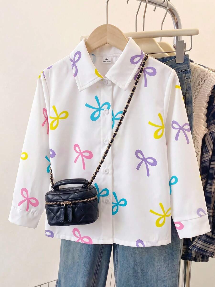 SHEIN 1件少女甜美俏皮風白色襯衫,光滑亮面布料,標準領口,前襟鈕扣開合,滿版彩色蝴蝶結印花,清新活潑,長袖,單鈕扣袖口,寬鬆版型,適合校園、外出、購物、日常穿著,春秋薄款單件 - 白色 - 查看 1