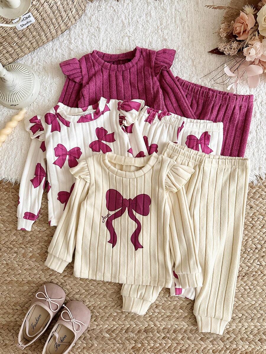 SHEIN Conjunto de 6 piezas para bebé niña con camiseta de cuello redondo, ribete de volantes, estampado de lazo en contraste, punto acanalado cepillado y color liso, y pantalones largos - Multicolor - Ver 1