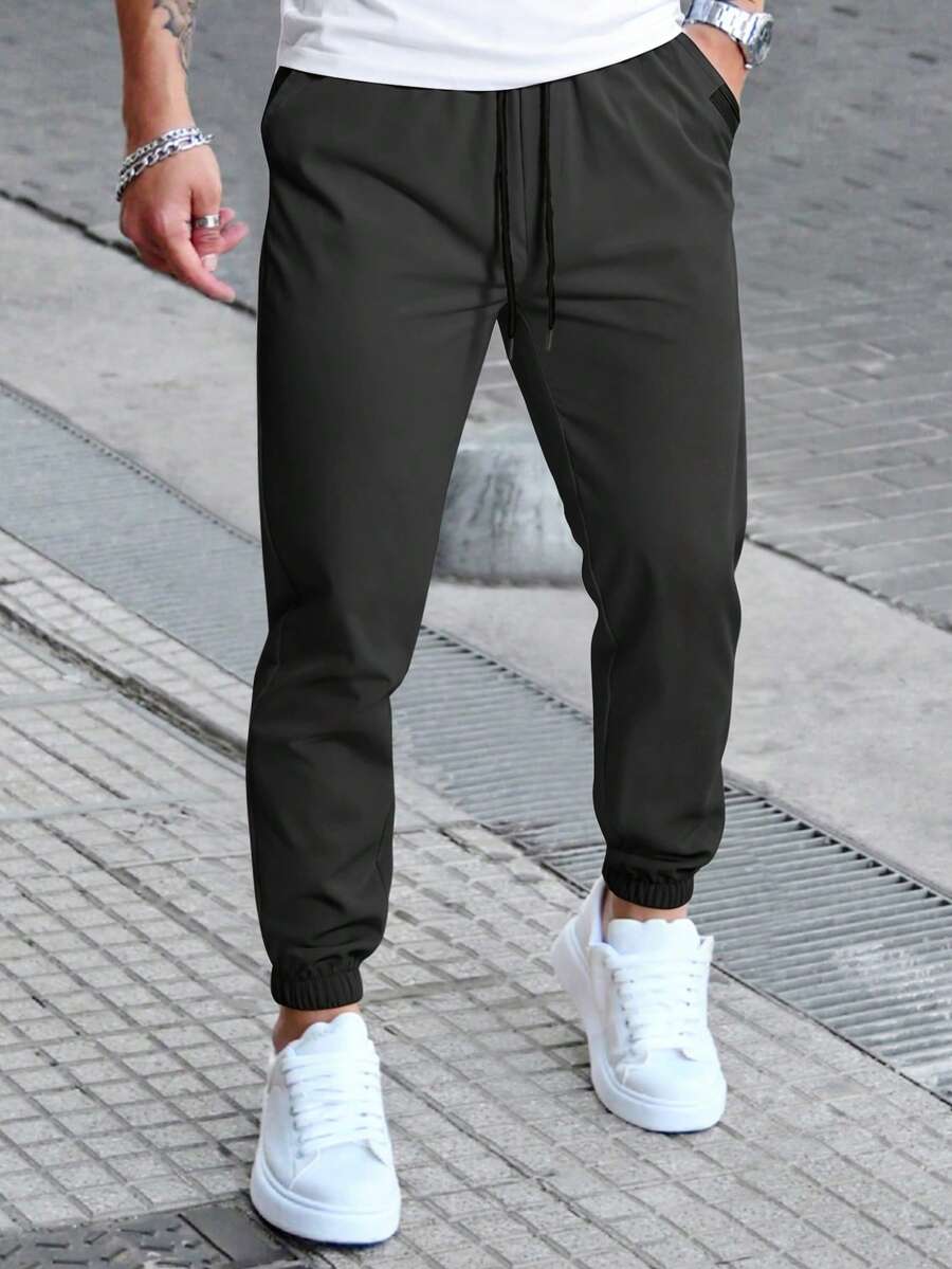 Manfinity Homme Pantalones casuales de unicolor con cordón en la cintura y bolsillos, otoño - Negro - Ver 1