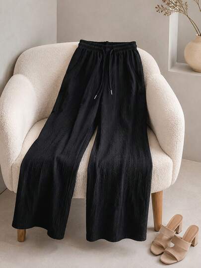 Pantalón de pierna ancha para mujer. Tela muy suave y cómoda. Ajuste de cintura natural con cordón ajustable. Colores lisos sin estampados. Sin bolsillos.