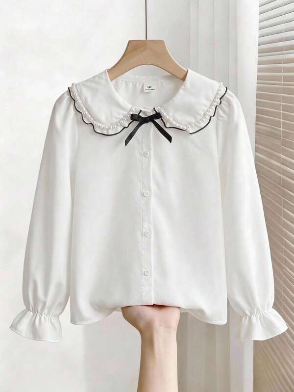 Blusa para niña preadolescente con cuello de perlas blancas y lazo, cuello vuelto con ribete de perlas, lazo negro con cordones en el pecho, diseño de puños acampanados, tela suave para la piel, estilo preppy dulce, top infantil para uso diario en el campus en primavera/otoño para niñas preadolescentes mayores, ropa infantil de diseño nicho y delicado