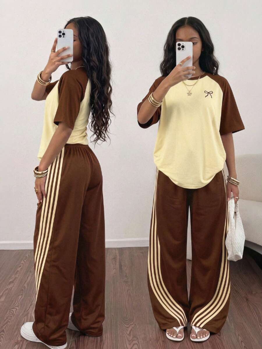 SHEIN Sparklyn 這套服裝包含一件粉色與綠色拼接的落肩短袖 T 恤，飾有蝴蝶結圖案 + 直筒寬腿褲，寬鬆休閒版型，甜酷混搭風格，適合日常穿著，搭配配件更顯活力 - 棕色 - 查看 1