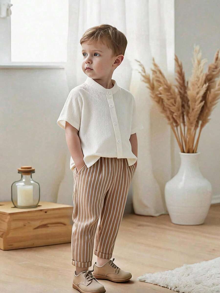 SHEIN Boys' Casual Comfortable Outdoor Vacation Travel Set, Small Stand Collar Short Sleeve Solid Color Button Placket Pleated Shirt With Mid-Waist Elastic Waist Striped Pattern Long Pants, Spring/Summer - Khaki - View 1