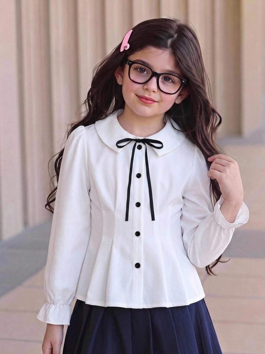 SHEIN بلوزة بيضاء أنيقة بأسلوب مدرسي للفتيات المراهقات، مزينة بفيونكة سوداء وأزرار متباينة، خصر مشدود وقصة A-Line، أكمام طويلة منفوخة، ملابس خريف/شتاء - أبيض - مشاهدة 1