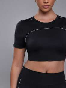 Voyena Women's Plus Size Seamless White Line Trim Sports Set Short Sleeve Flare Pants - Black - View 7