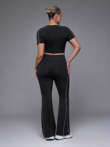 Voyena Women's Plus Size Seamless White Line Trim Sports Set Short Sleeve Flare Pants - Black - View 2