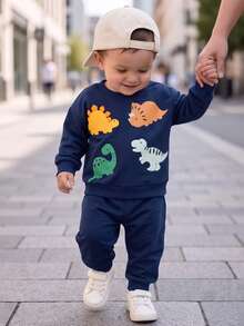 SHEIN Playful Pals طقم سويت شيرت وبنطلون رياضي بطبعة ديناصور للأولاد الرضع - متعدد الألوان - مشاهدة 1