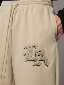 SUMWON 低裆慢跑运动裤，宽松抓绒面料，休闲居家服，街头风，带 LA Logo 贴片，抽绳松紧腰带，纯色 - 卡其色 - 查看 7