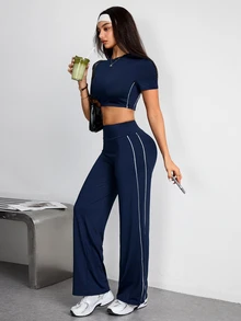 Easithlete Bộ đồ thể thao nữ gồm áo thun croptop cổ tròn tay ngắn và quần dài - Màu xanh hải quân - Xem 1