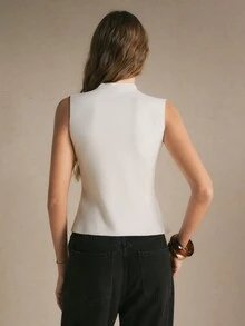 Poéselle Women's White Sleeveless Knit Top, Mock Neck Slim-Fit Sweater Vest With Decorative Gold Buttons, Asymmetric Hem And Side Slit, Elegant Casual Top - Beige - View 9