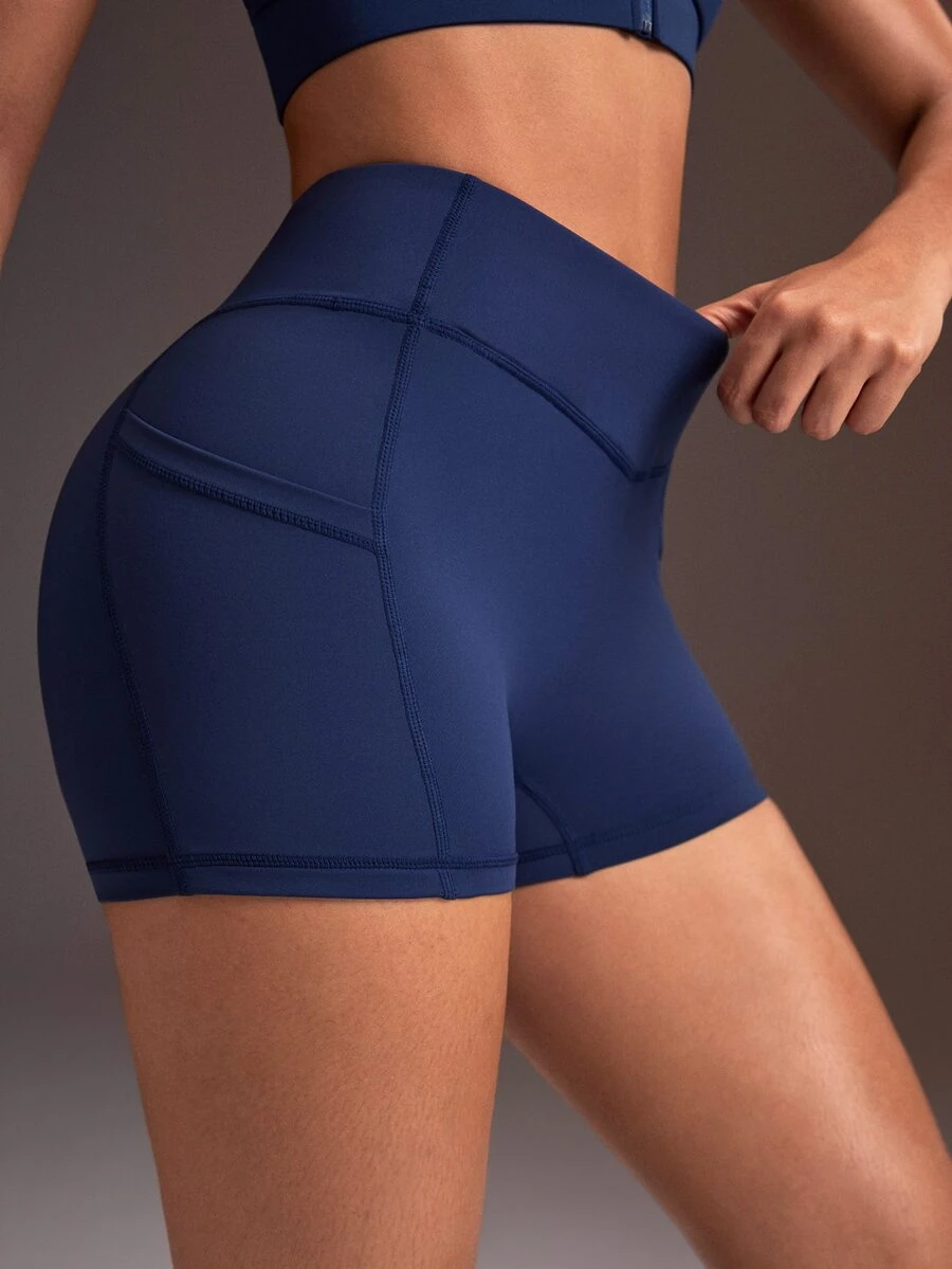 Powerista Women's Minimalist Solid Color V-Waist High-Waisted Side Pocket Athletic Shorts - Navy Blue - View 1