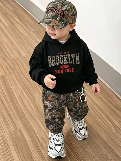 THE HAPPY LOOK Kids Young Boy Letter Pattern Black Pullover Sweatshirt With Elastic Waist, Camouflage Style Leaf Print Pattern Jogger Pants 2-Piece Set