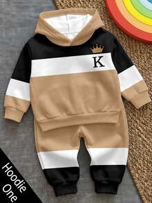 SHEIN كنزة رياضية مريحة وكاجوال للأطفال والفتيان المراهقين مع بطانية رأس، بطبعة نمط خطوط كلاسيكية ريترو، وطبعة نمط تاج لطيفة ووسيمة، وطبعة نص كلاسيكية King، وطبعة نمط K، مناسبة لفصل الخريف/الشتاء، ومناسبة لموسم العودة إلى المدرسة - كاكي - مشاهدة 1
