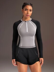 Powerista بلوزة رياضية نسائية بأكمام طويلة بتصميم راجلان وألوان متباينة مع سحاب وفتحة نصفية - الأسود - مشاهدة 3