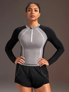 Powerista بلوزة رياضية نسائية بأكمام طويلة بتصميم راجلان وألوان متباينة مع سحاب وفتحة نصفية - الأسود - مشاهدة 5