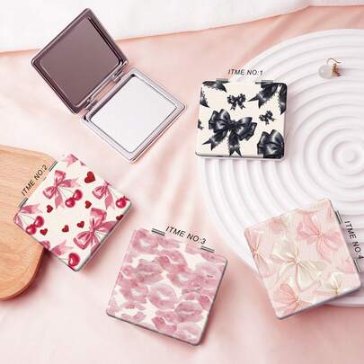 Y2K系列折叠化妆镜，轻薄便携，背面带粘胶，适用于多种场景和所有用户。方形折叠设计，方便携带。独特的Y2K卡通风格，饰有蕾丝、蝴蝶结、爱心、樱桃和嘴唇图案。可靠耐用，防刮擦。赠品、旅行、平价好物、旅行必备