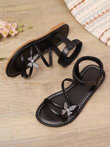 1双黑色加大码女童时尚凉鞋，纯色PU编织带，闪亮彩色蝴蝶装饰，弹性踝带，圆头露趾，平底防滑舒适优雅可爱罗马凉鞋，适合3-15岁女孩，日常、休闲、派对、旅行皆宜，2026春夏款 - 黑色 - 查看 4
