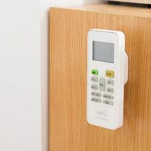 Soporte retráctil para control remoto con cierre magnético - Organizador de cables de  para múltiples controles remotos, diseño de montaje en pared ahorrador de espacio, compatibilidad universal para controles de TV/Aire acondicionado/Ventilador (Blanco/Negro)