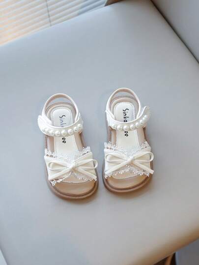 1 Par de sandalias de niña, versión de verano, zapatos planos para niños pequeños, estilo pastoril beige chic, adecuado para campamento, atuendo diario, punta redonda, lazo, adorno de encaje, perlas
