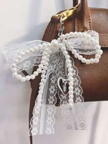 1 móc khóa nơ ren và ngọc trai dễ thương, mặt dây chuyền ví, móc khóa túi xách, đồ trang trí giày dép, đồ trang trí nơ, phụ kiện treo ngọc trai hình trái tim (Nơ đã được cố định trước khi giao hàng. Có thể bị lộn xộn trong quá trình vận chuyển, đây là hiện tượng bình thường. Chỉ cần sắp xếp lại.) - trắng - Xem 5