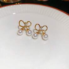 Andkiss 1 paire de boucles d'oreilles clous simples et élégantes en forme de nœud papillon, convient pour un port quotidien