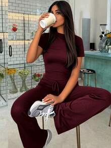 Wiosenne i jesienne damskie modne bluzki z krótkim rękawem odsłaniające pępek, dopasowane, sznurowane spodnie z rozszerzanymi nogawkami, sportowe garnitury