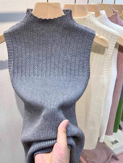 一件女士无袖插肩针织毛衣上衣，领子可拆卸，撞色设计，颜色包括黑色、白色、米色、灰色、粉色和绿色，适合圣诞节装饰穿着