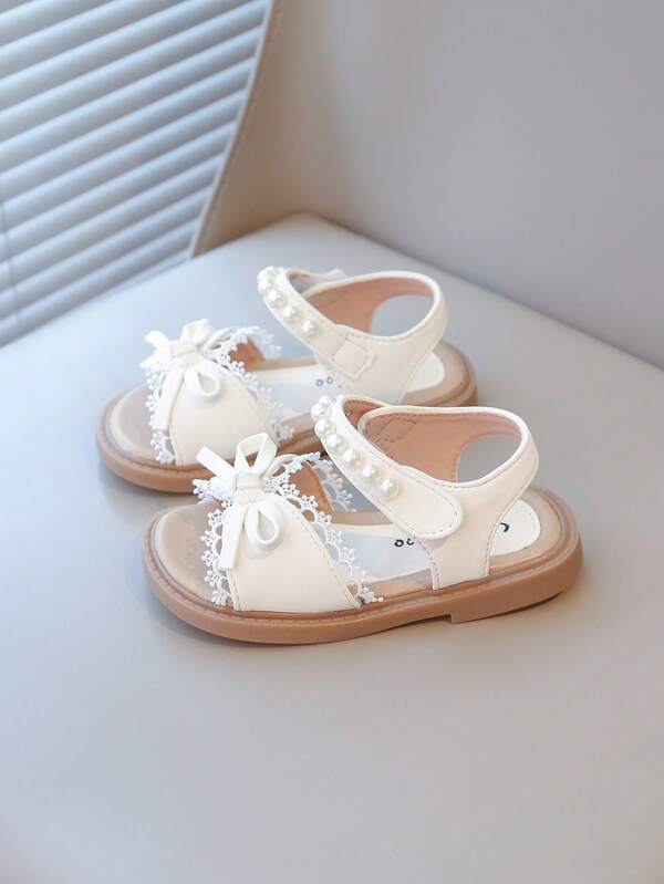 Nuevas sandalias para niñas pequeñas con perlas, moños y decoraciones de flores de encaje, suela suave y antideslizante, elegantes y cómodas para el verano