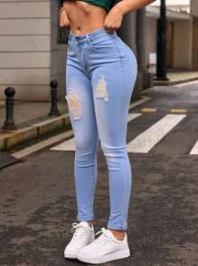 Mujer skinny jeans azules claros con desgaste