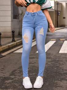 Mujer skinny jeans azules claros con desgaste